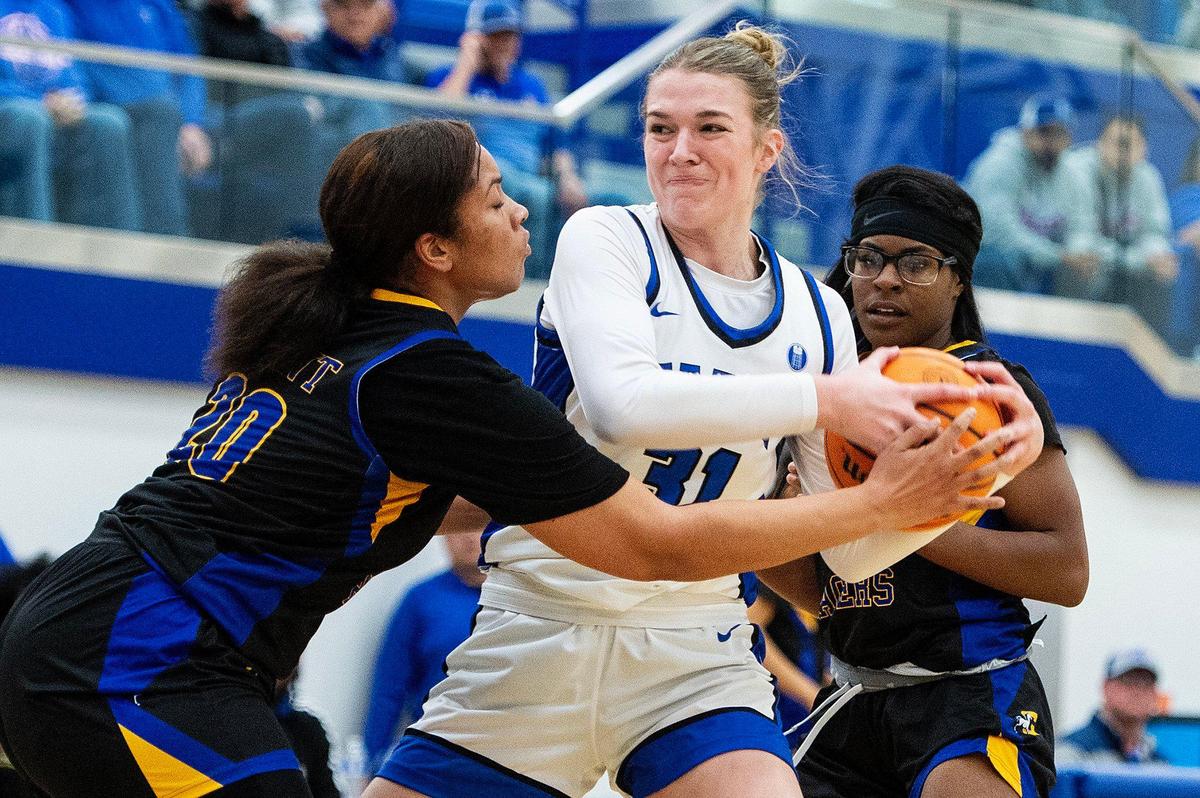 Atwater senior Cami Gibson (31) fights for possession of the ball with Grant sophomore Oranell Latham (20) during a game at Atwater High School in Atwater, Calif., on Tuesday, Feb. 25, 2025. The Falcons beat the Pacers 70-54.