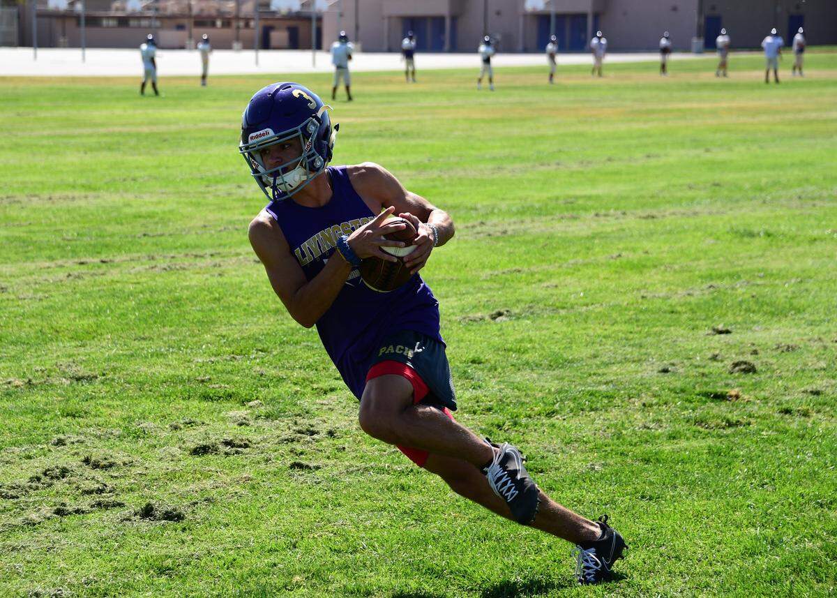 Livingston senior receiver Cooper Winton hauls in a pass and heads up field during practice at Livingston High on Wednesday, Sept. 11, 2019.