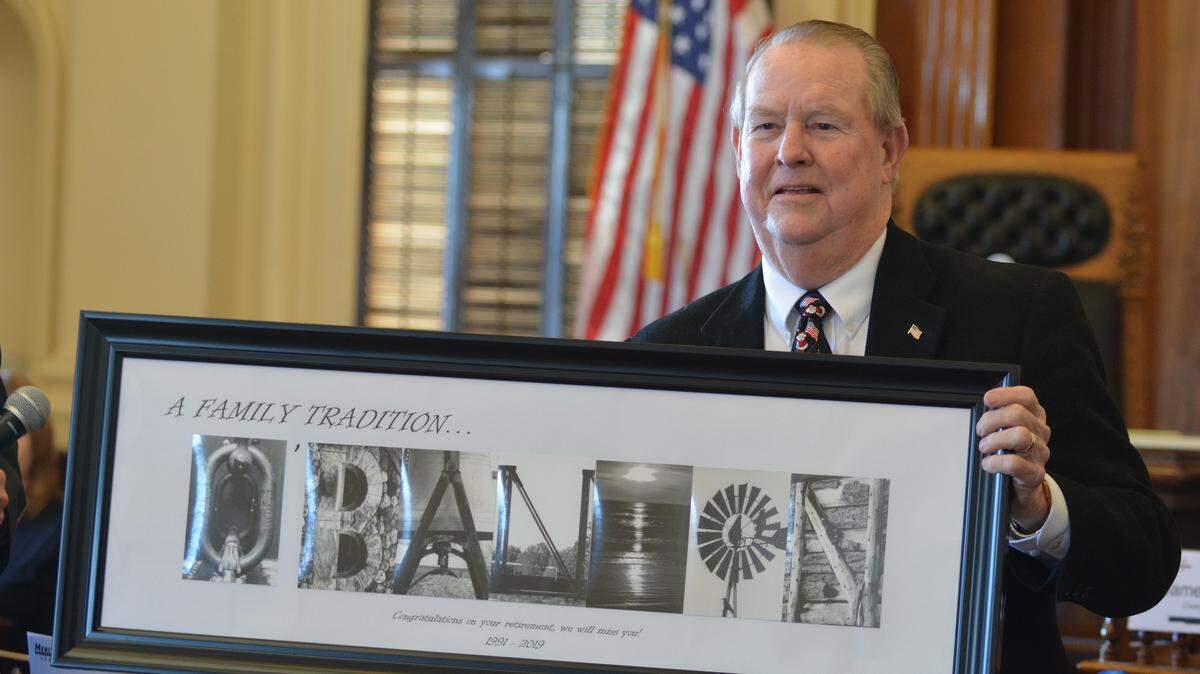 Longtime Merced County Supervisor Jerry O’Banion displays one of the many gifts he received from several agencies and county employees at his final board meeting Tuesday, Dec. 18, 2018, after 28 years of service.