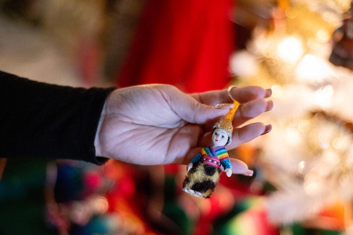Susana Santana, 33, of Merced, places figurines on the Healthy House Merced Christmas tree at the Merced County Courthouse Museum on Wednesday, Nov. 27, 2024. The annual Christmas tree exhibit features more than 80 trees and runs through Dec. 30. A Christmas Tree open house will be held on Dec. 1 and include live entertainment including musical performances.