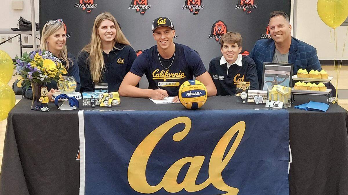 Merced High senior Easton Hamm (center) is joined by his family (from left to right) mother Erin, sister Ellie, brother Eli and father Eric, as he signs his national letter of intent to accept a water polo scholarship to Cal during a ceremony at Merced High School on Monday, Nov. 15, 2021.