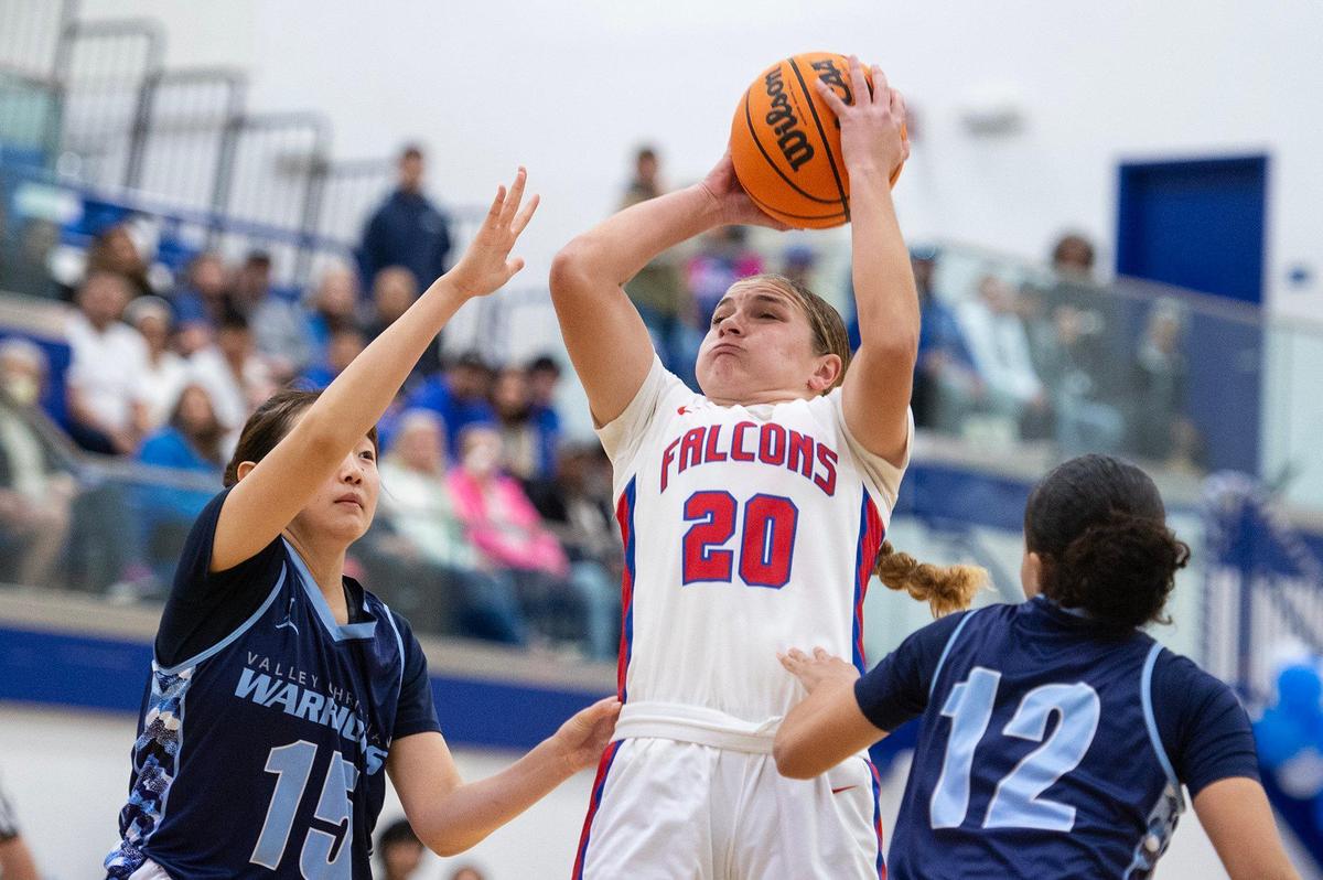 Atwater junior Madison Hiler (20) pulls up to attempt a jump shot during a CIF NorCal Division II playoff game against Valley Christian at Atwater High School in Atwater, Calif., on Tuesday, March 4, 2025. The Falcons beat the Warriors 58-39.