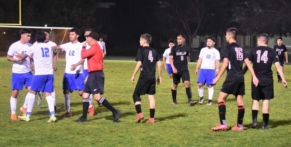 The referee had to separate the Delhi High and King City players after a physical play during a Northern California Regional Playoff match on Tuesday, March 1, 2022 at Delhi High School in Delhi, Calif.
