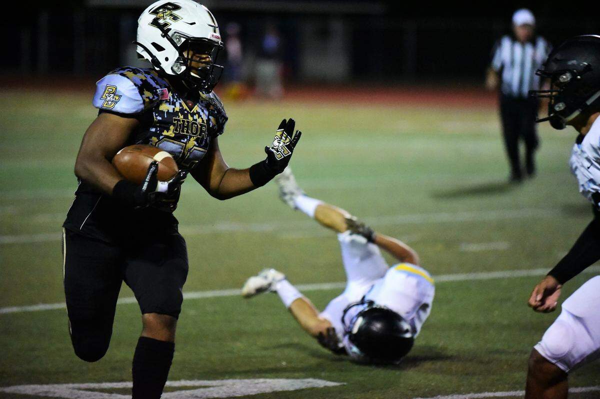 Buhach Colony running back Anthony Berry prepares to stiff arm an El Capitan defender during the Thunder’s 64-0 win over the Gauchos on Thursday, Oct. 3, 2019 at Dave Honey Stadium.