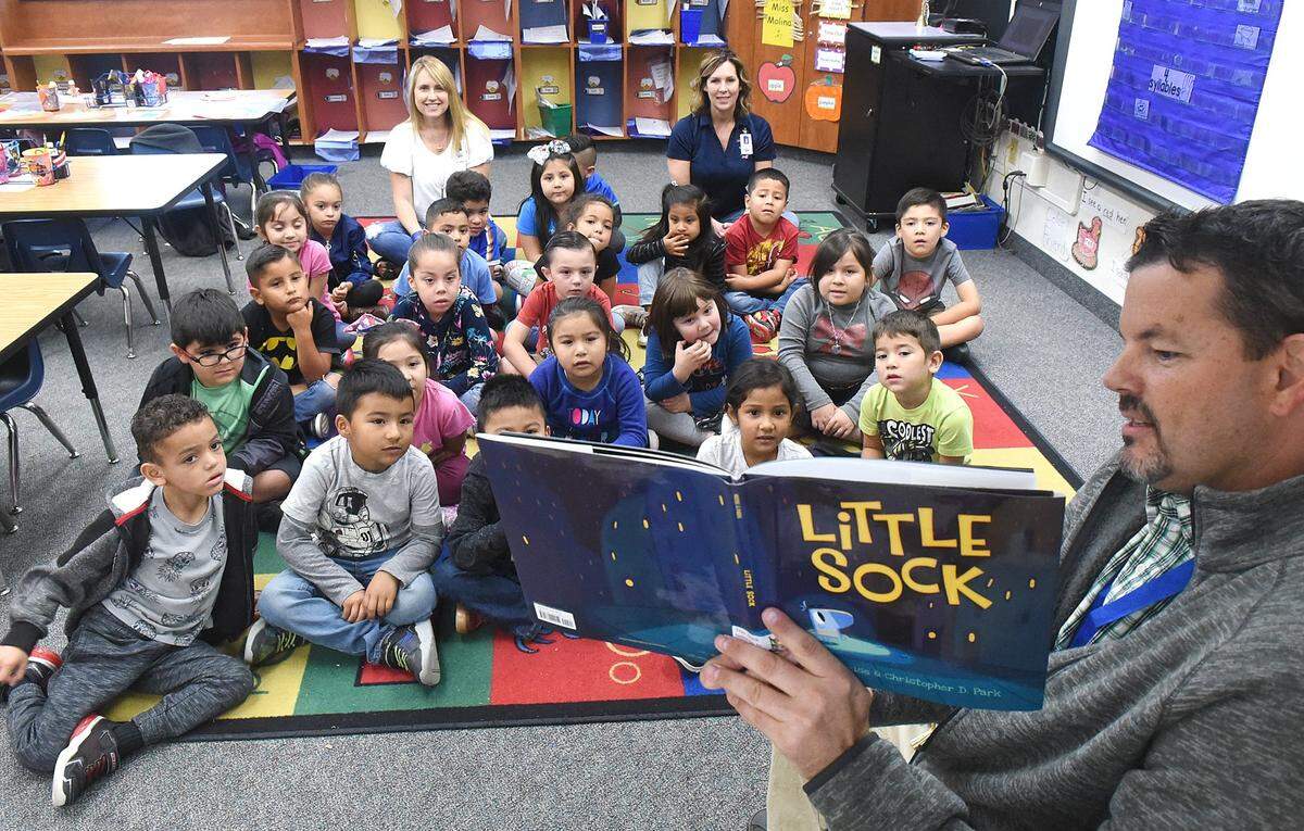 Los Banos Unified School District Board of Trustee, Luis Castro, right, reads the book, “Little Sock” to teacher Lynn Cotta’s kindergarten class on Oct. 25, 2019, at Lorena Flasco Elementary School in Los Banos.