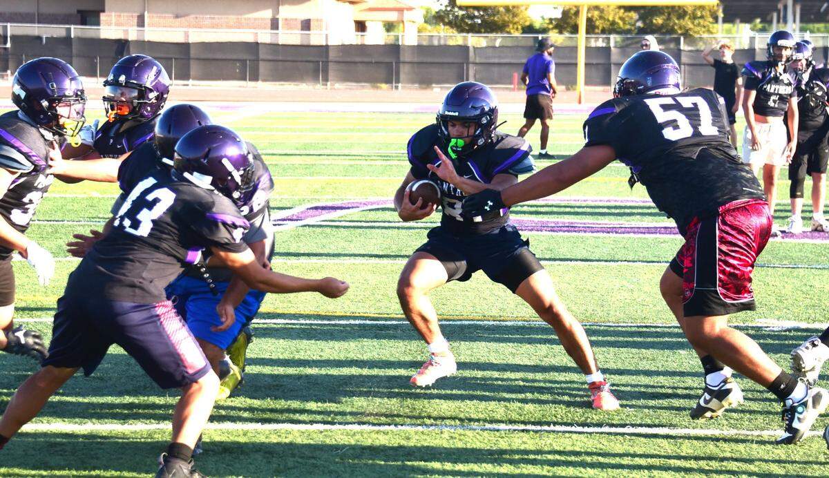 Pacheco High senior running back Isaac Valencia looks to run the ball through a hole during practice on Thursday, Aug. 1, 2024.