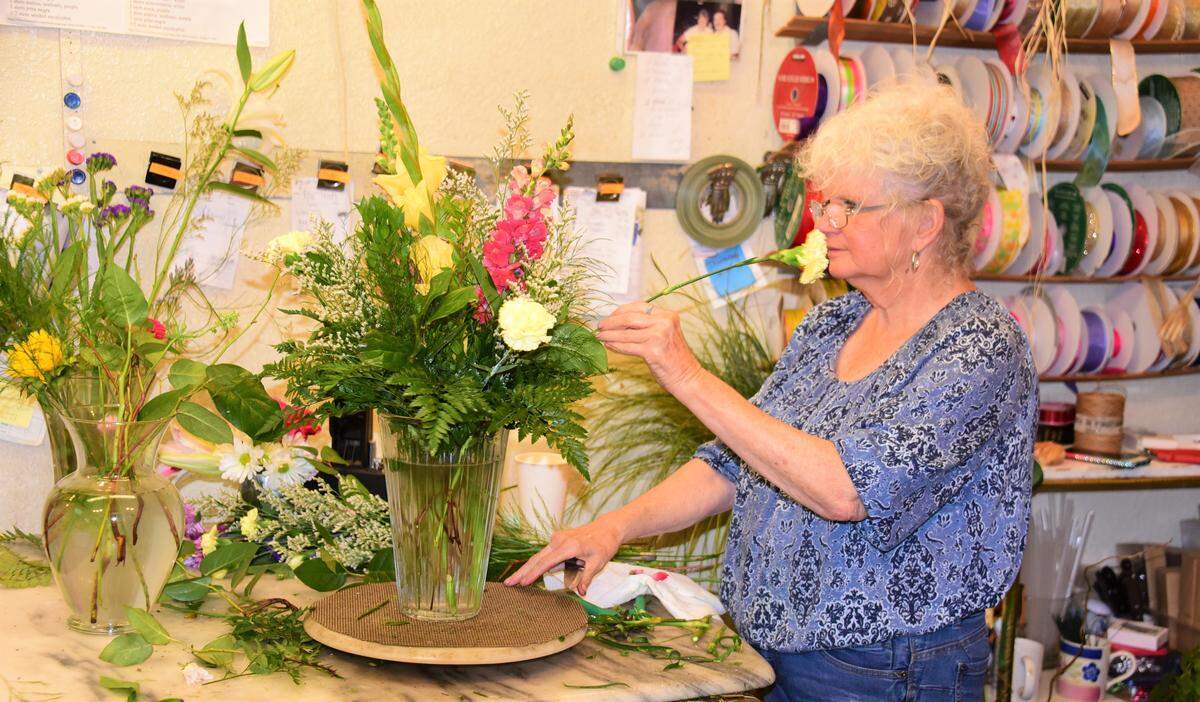 Terry Vargas works on a flower arrangement at A Blooming Affair Floral & Gift Shop on Friday, May 8, 2020. The shop, which reopened on Friday, has 100 deliveries scheduled for Saturday.