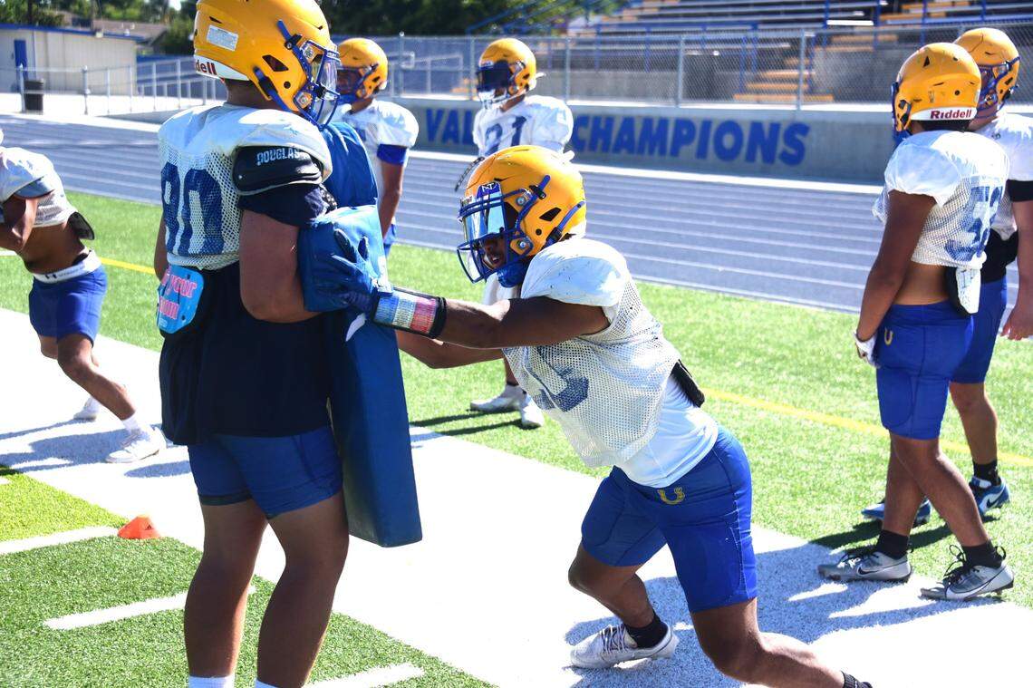 Dos Palos High School junior Andre Flores participates in defensive drills during practice on Tuesday, Aug. 13, 2024.