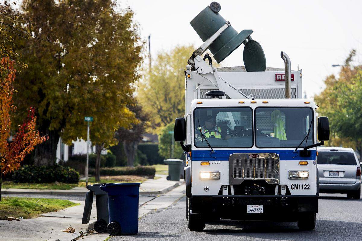 A City of Merced truck is shown collecting green waste in Merced Calif., Tuesday, Dec. 8, 2015. 