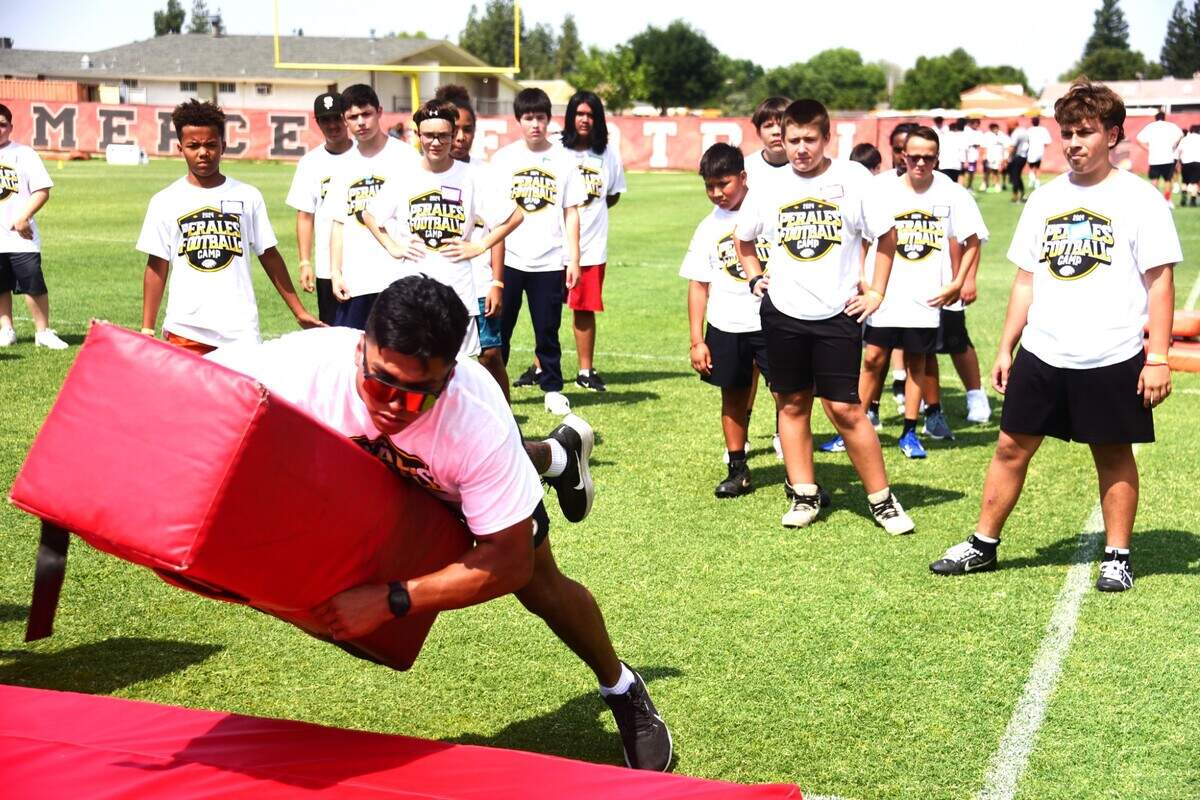 Pittsburgh Steelers linebacker David Perales shows kids how to tackle at the David Perales Football Camp held at Merced High School on Saturday, July 13, 2024 in Merced, Calif.