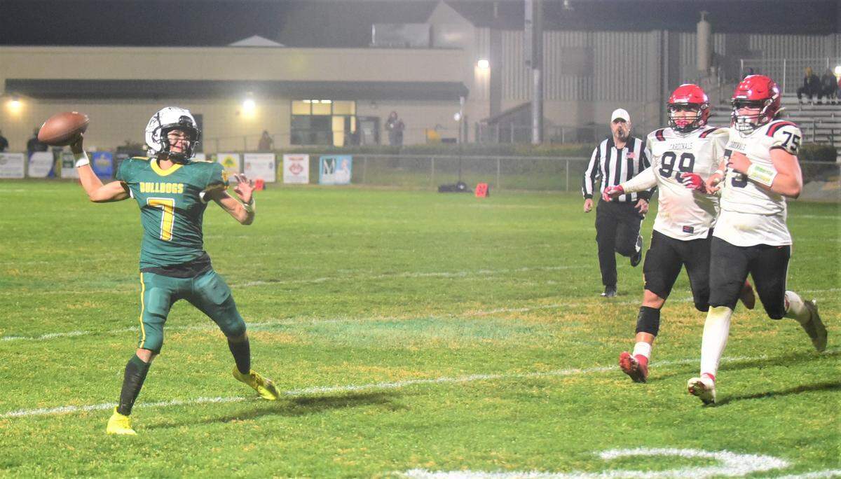 Le Grand High School quarterback Julian Bucio throws a pass on the run against Woodland Christian in the Sac-Joaquin Section Division VII semifinals on Friday, Nov. 18, 2022 at Le Grand High School.