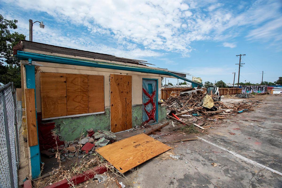 A section of a building stands next to a pile of debris as the Siesta Motel, located at 1347 W. 16th Street, in demolished in Merced, Calif., on Thursday, Aug. 4, 2022.