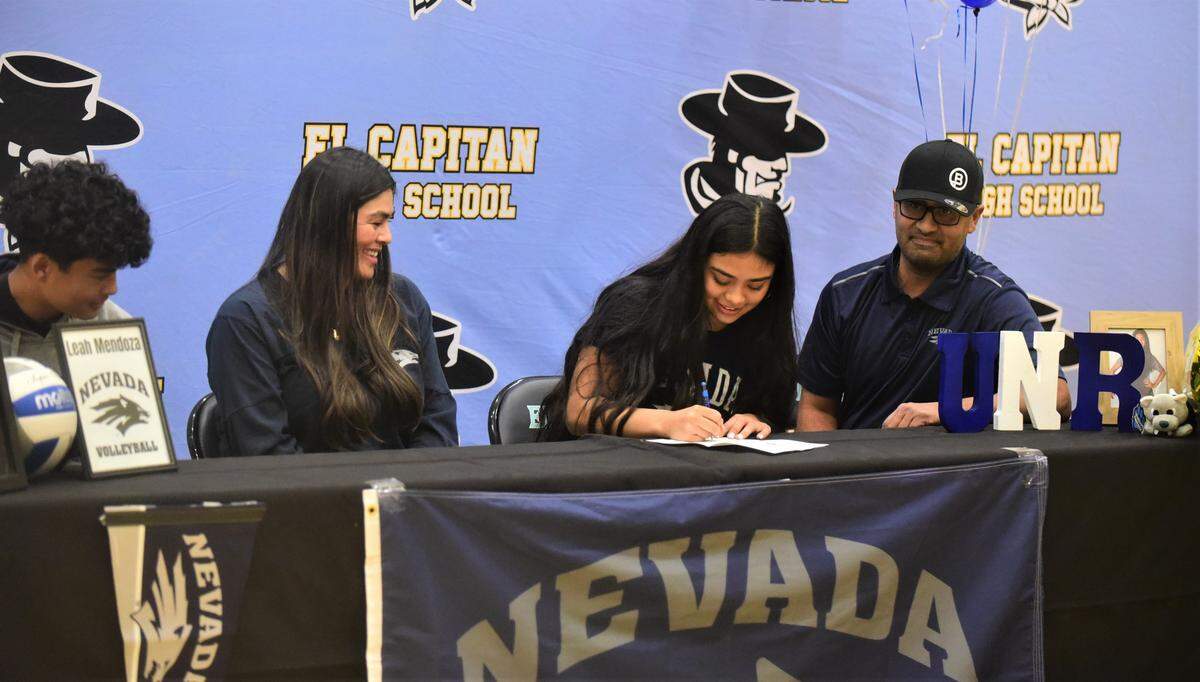 El Capitan High School senior Leah Mendoza signs her national letter of intent to play volleyball at the University of Nevada-Reno as her family (from left to right) brother Sergio, mother Crystal, father Sergio look on, on Thursday at El Capitan High School in Merced, Calif.