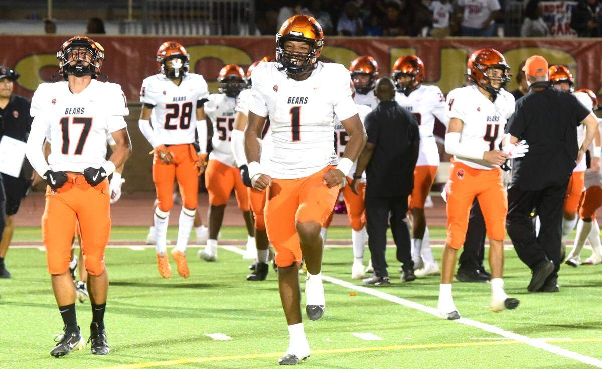 Merced High quarterback Quintell Dupree (1) and teammate Nehemiah De la cruz (17) celebrate the Bears’ 32-8 victory over Golden Valley in the Battle for the Mayor’s Cup on Friday, Oct. 4, 2024.