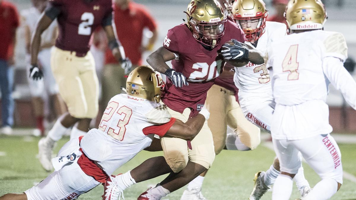 Golden Valley senior Jaren Phillips (20) attempts to break a tackle during a game against Centennial at Veterans Stadium on the campus of Golden Valley High School in Merced, Calif., on Friday, Aug. 31, 2018. The Golden Hawks beat the Cougars 38-15.