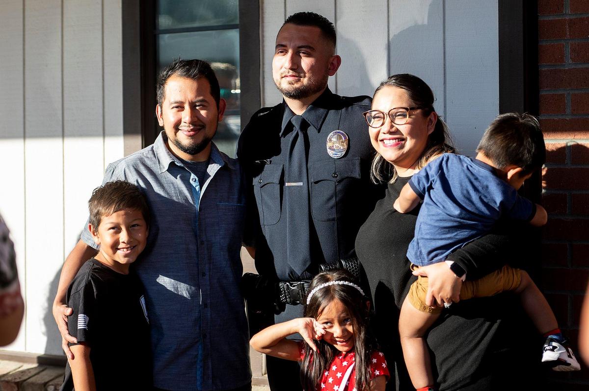 Gustine Police Department Reserve Officer Emanuel Gonzalez, center, poses for photos following a swearing in ceremony for four new Gustine Police Department Reserve Officers in Gustine, Calif., on Tuesday, June 20, 2023.