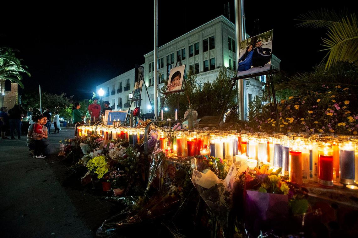 Candles and flowers beneath photos of kidnapping victims 8-month-old Aroohi Dheri, her parents Jasleen Kaur, 27, and Jasdeep Singh, 36, and her uncle Amandeep Singh, 39, during a vigil at Bob Hart Square in Merced, Calif., on Sunday, Oct. 9, 2022.