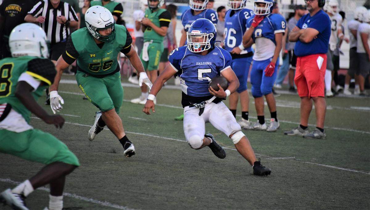 Atwater High School senior running back Josue Garcia runs the ball during a scrimmage against Roosevelt High School on Friday, Aug. 12, 2022 at Dave Honey Stadium in Atwater, Calif.
