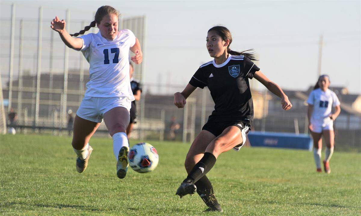 El Capitan High sophomore Dada Saeteurn passes the ball as Sierra junior Becca Thomson challenges during a quarterfinal playoff match on Wednesday, Feb. 16, 2022 at El Capitan High School in Merced, Calif.