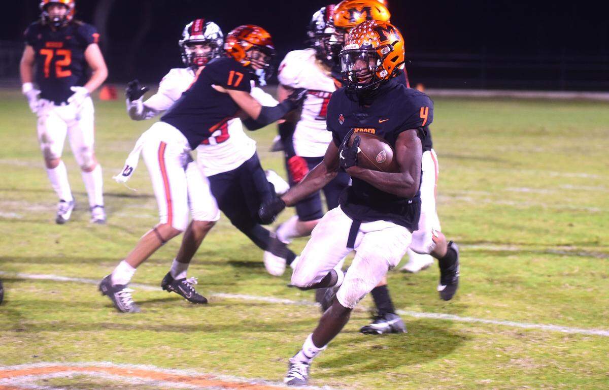 Merced High School senior Chase Smith (4) runs the ball against Bella Vista. Smith scored three touchdowns in the Bears’ 47-0 playoff win.