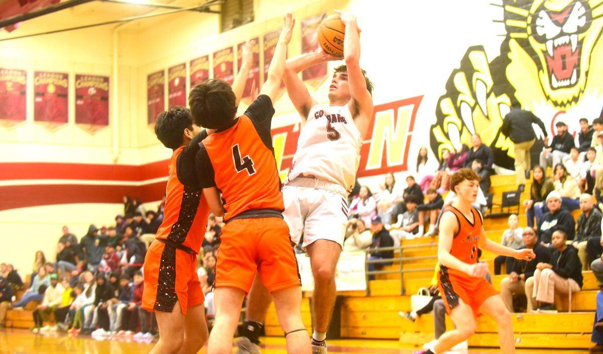 Golden Valley High School senior guard Joey Spielman (5) goes up for a shot against two Merced defenders during a basketball game on Wednesday, Jan. 3, 2023 at Cougar Arena.