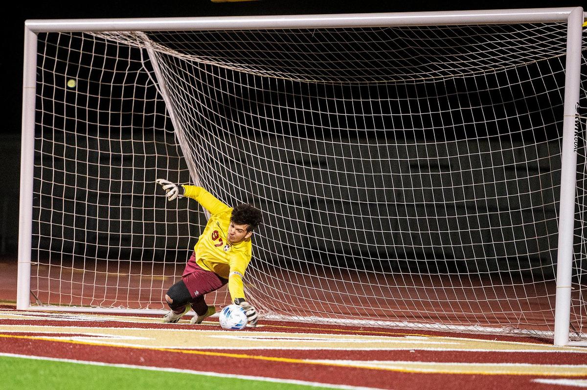 Golden Valley senior goalkeeper Manuel Zarco Zarate makes a save on a Rocklin penalty kick during a Division 2 playoff game at Golden Valley High School in Merced, Calif., on Tuesday, Feb. 13, 2024. The Cougars beat the Thunder 3-0.