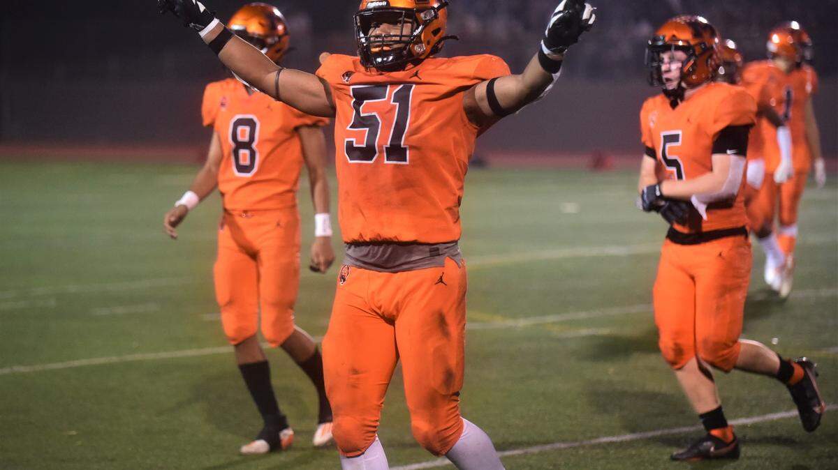 Merced High senior defensive lineman Jaylen Thao-Booth (51) celebrates a defensive stop as he comes off the field during a game against Golden Valley on Friday, Oct. 29, 2021 at Veterans Stadium in Merced, Calif.