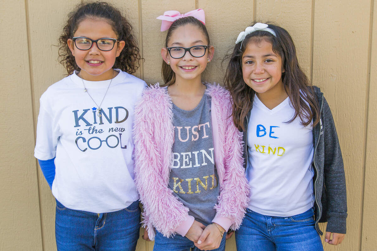 Charleston Elementary School students (from left to right) Malia Fuentes, Madalyn Silva, Mikayla Luna ear kindness shirts.