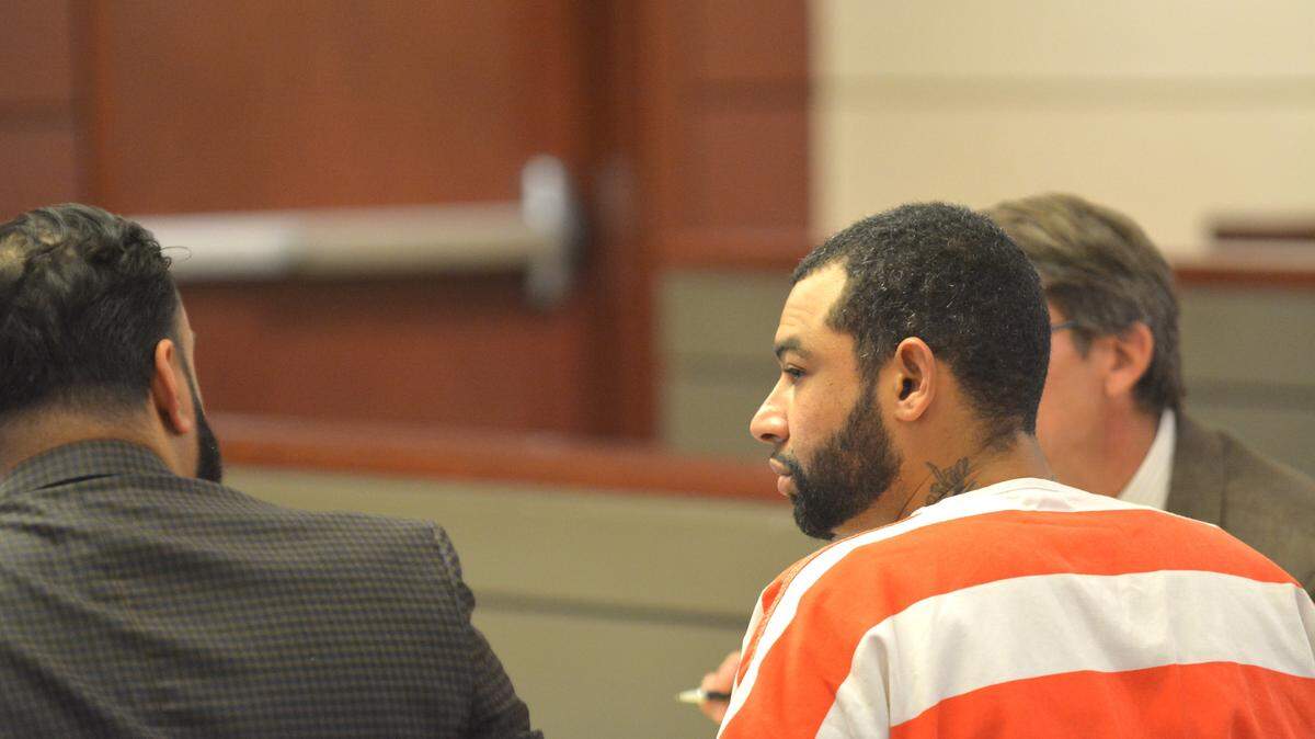Jerome Slayton, 30, of San Jose, talks with his public defender, Ramnik Samrao, in Merced Superior Court Friday, Aug. 10, 2018, in Merced. Slayton pleaded not guilty to killing 29-year-old Michael Riley in Merced in 2008. Charges were dismissed Friday and Slayton was re-arrested as prosecutors plan to re-file the charges.