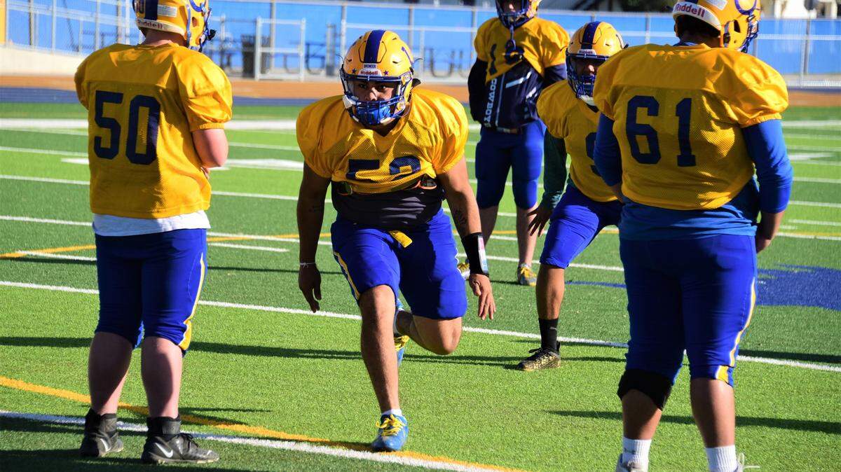 Dos Palos senior defensive end J. Tapia (52) rushes the passer during practice on Tuesday, Oct. 12, 2021 at Ike Frankian Field on the campus of Dos Palos High School.