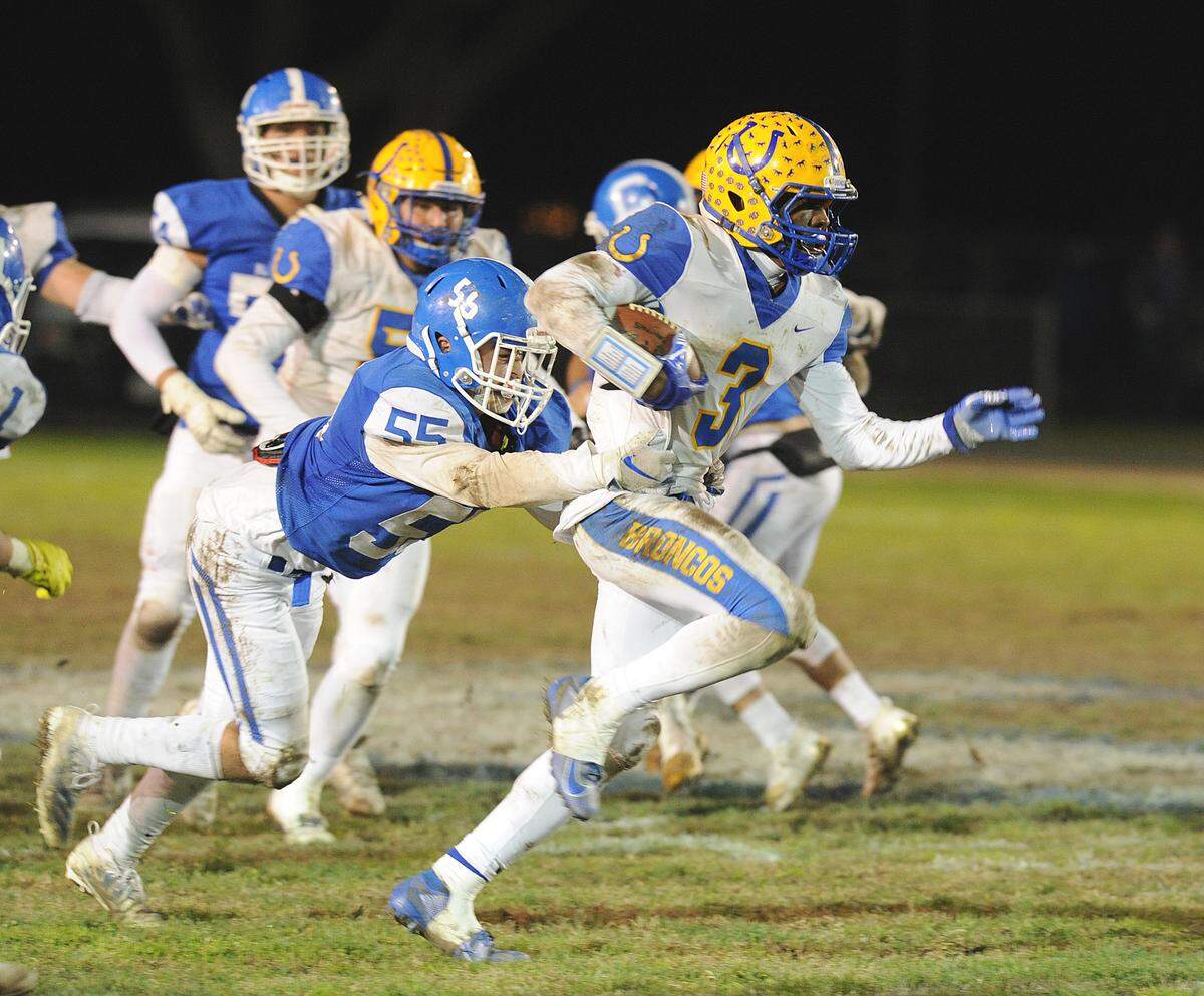 Dos Palos running back, Tyree Martin, pulls Caruthers lineman, Dylin Ferreira in the second quarter Friday night, Nov. 29, 2019 in Caruthers.