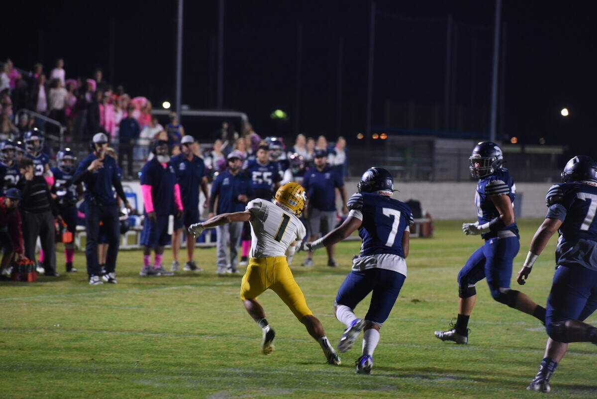 Mariposa County senior athlete/defensive back Laten Butler evades tacklers after intercepting a pass from Marcus Gray on Friday, October 17, 2025.