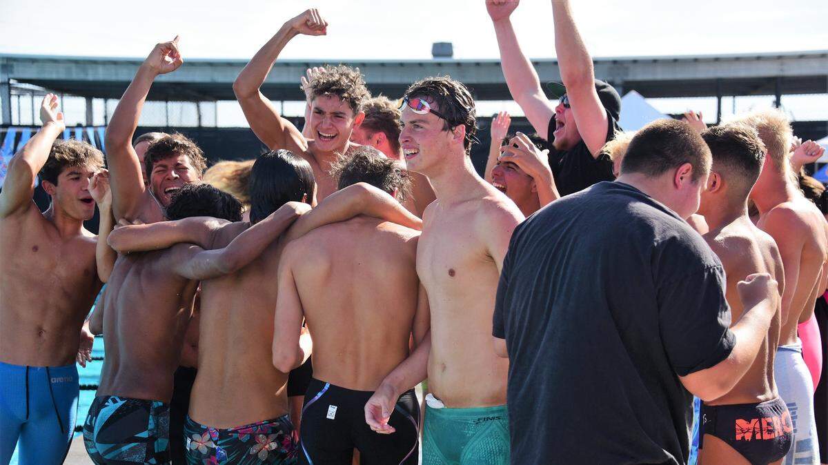 The Merced High boys celebrate after learning they won the Central California Conference championship on Thursday after the CCC championships at El Capitan High in Merced, Calif.