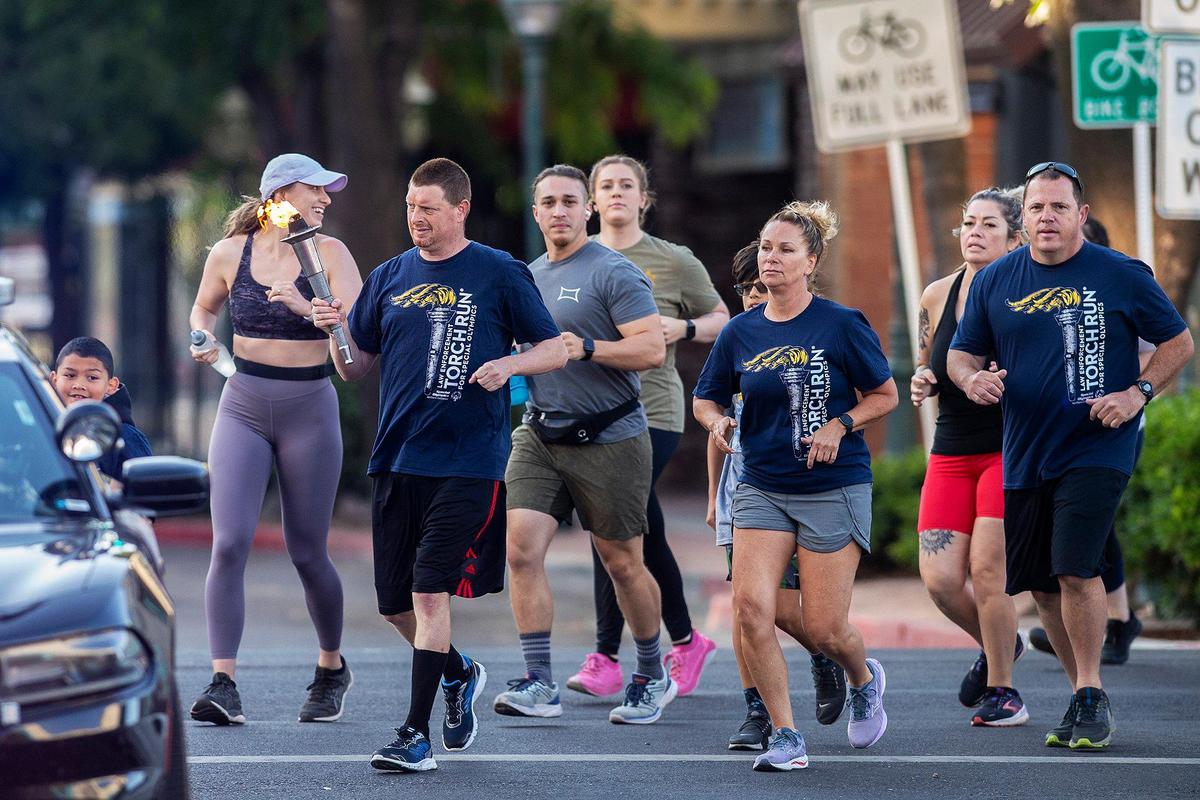 Participants in the Law Enforcement Torch Run for Special Olympics Northern California turn onto West Main Street in Merced, Calif., on Thursday, June 15, 2023.