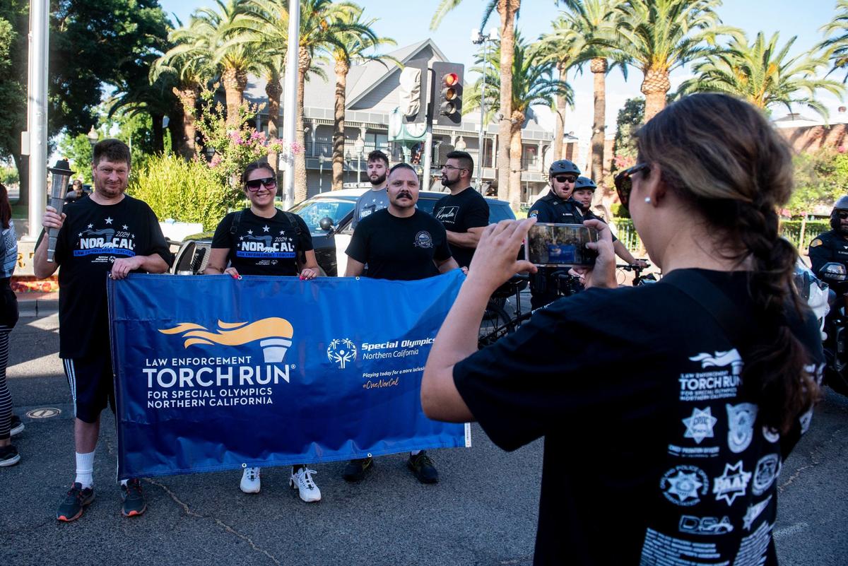 Participants gather for photos after participating in the annual Law Enforcement Torch Run for Special Olympics Northern California in Merced, Calif., on Wednesday, June 26, 2024.