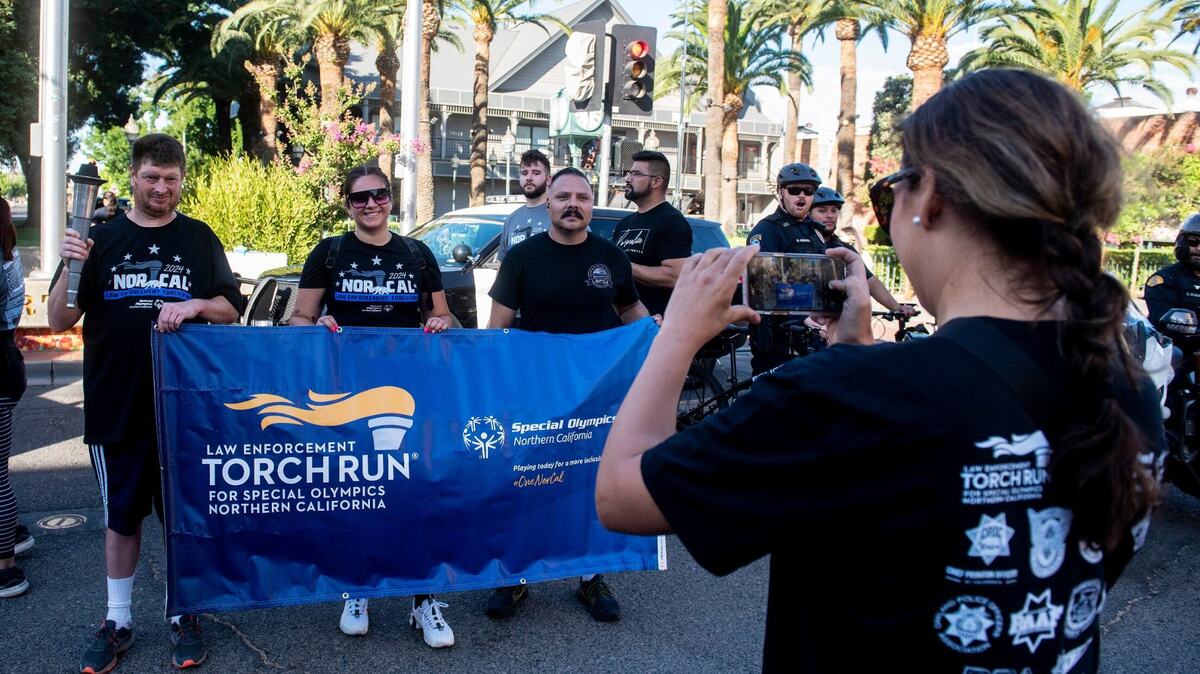 Participants gather for photos after participating in the annual Law Enforcement Torch Run for Special Olympics Northern California in Merced, Calif., on Wednesday, June 26, 2024.