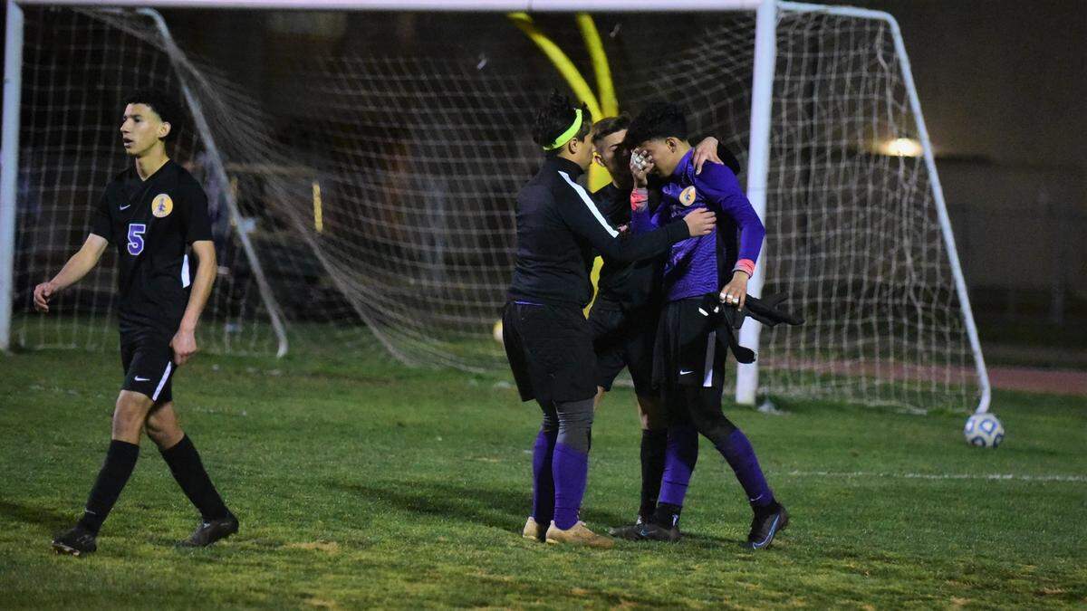 Livingston High players console Wolves freshman goalie Luis Sandoval after Livingston loses to Dixon in a playoff match on Tuesday, Feb. 15, 2022 in Livingston, Calif.