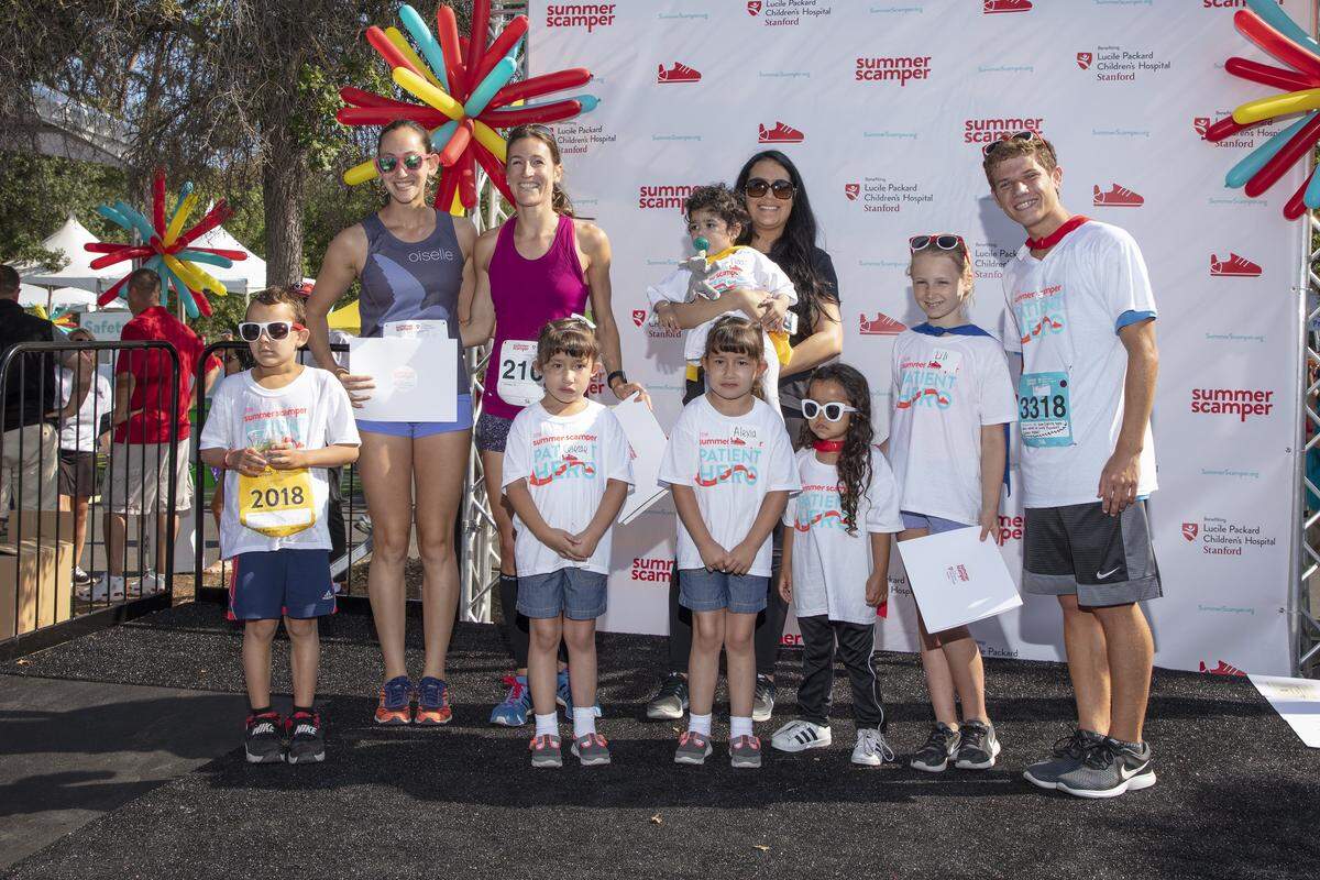 Lucca Lorenzi (right) poses for photos with other patient heroes at the Summer Scamper in Palo Alto on Sunday, June 24, 2018. Lorenzi helped put together a donation of 800 art supply items to the Lucile Packard Children's Hospital Stanford last summer. Together with his family, he helped come up over $5,000 in donations for the Lucile Packard Foundation for Children's Health.