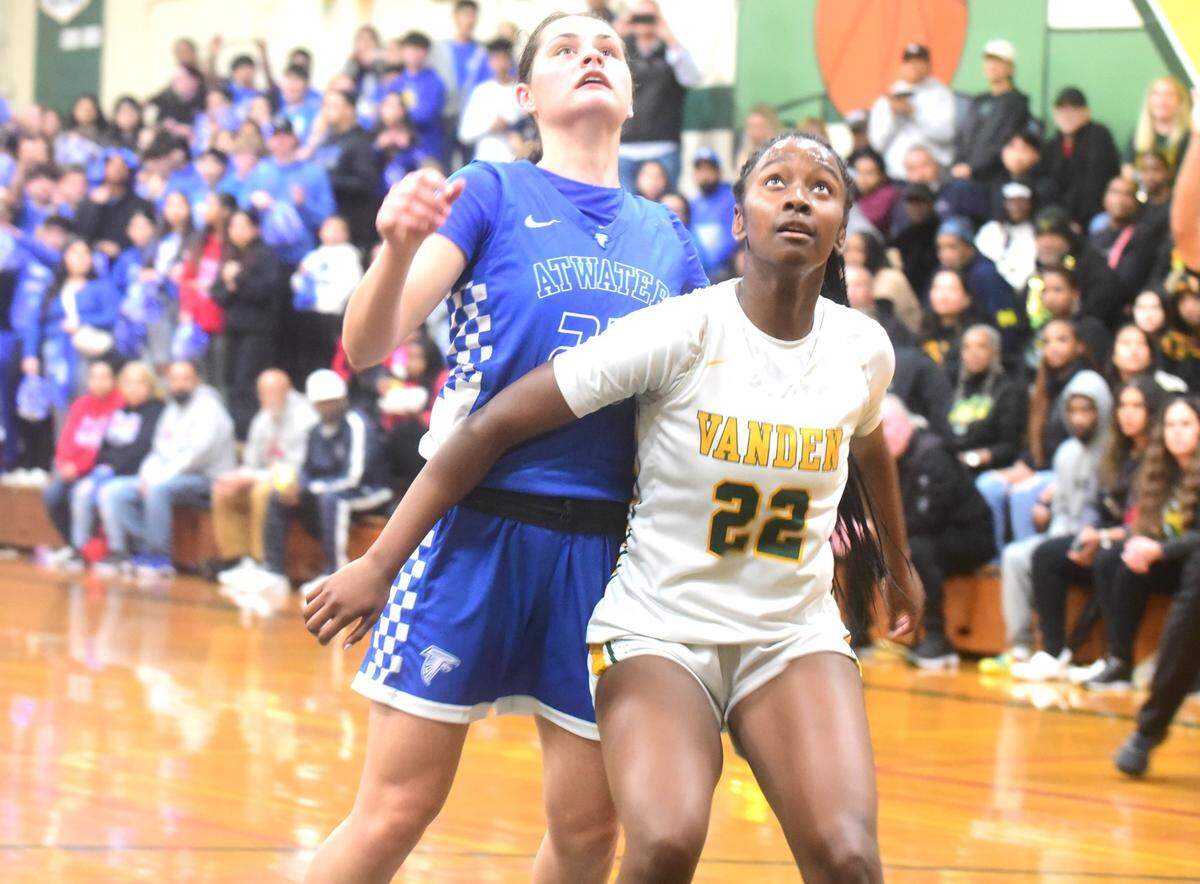 Vanden High School junior Calonni Holloway (22) battles Atwater’s Cami Gibson for a rebound during a playoff game on Monday, Feb. 19, 2024.