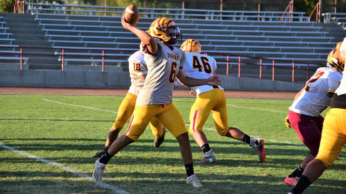 Los Banos High School junior quarterback David Herrera throws a pass during practice on Wednesday, Aug. 3, 2022 at Loftin Stadium in Los Banos, Calif.