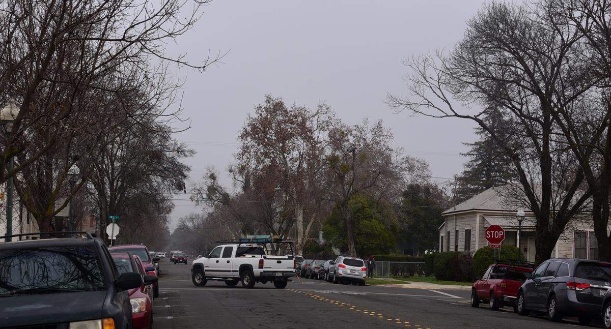 A white pickup truck turns left on W 18th Street from Martin Luther King Jr. way as dense fog hangs over Merced on Monday Jan. 15 2018.