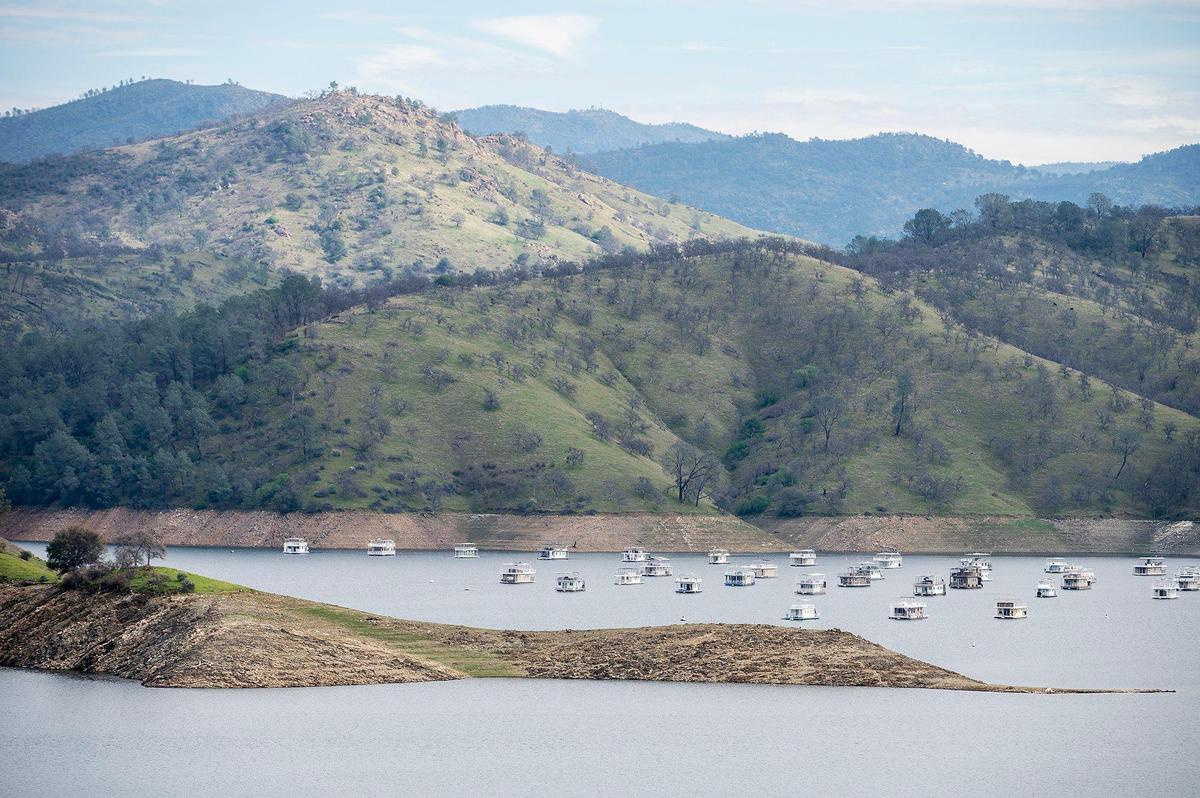 Houseboats float on the water at Lake McClure in Mariposa County, Calif., on Monday, Feb. 24, 2025.