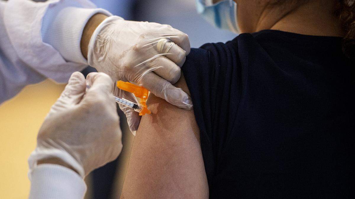A patient receives a COVID-19 vaccine at a clinic inside the Cesar E. Chavez Middle School gymnasium in Planada, Calif., on Thursday, March 4, 2021.