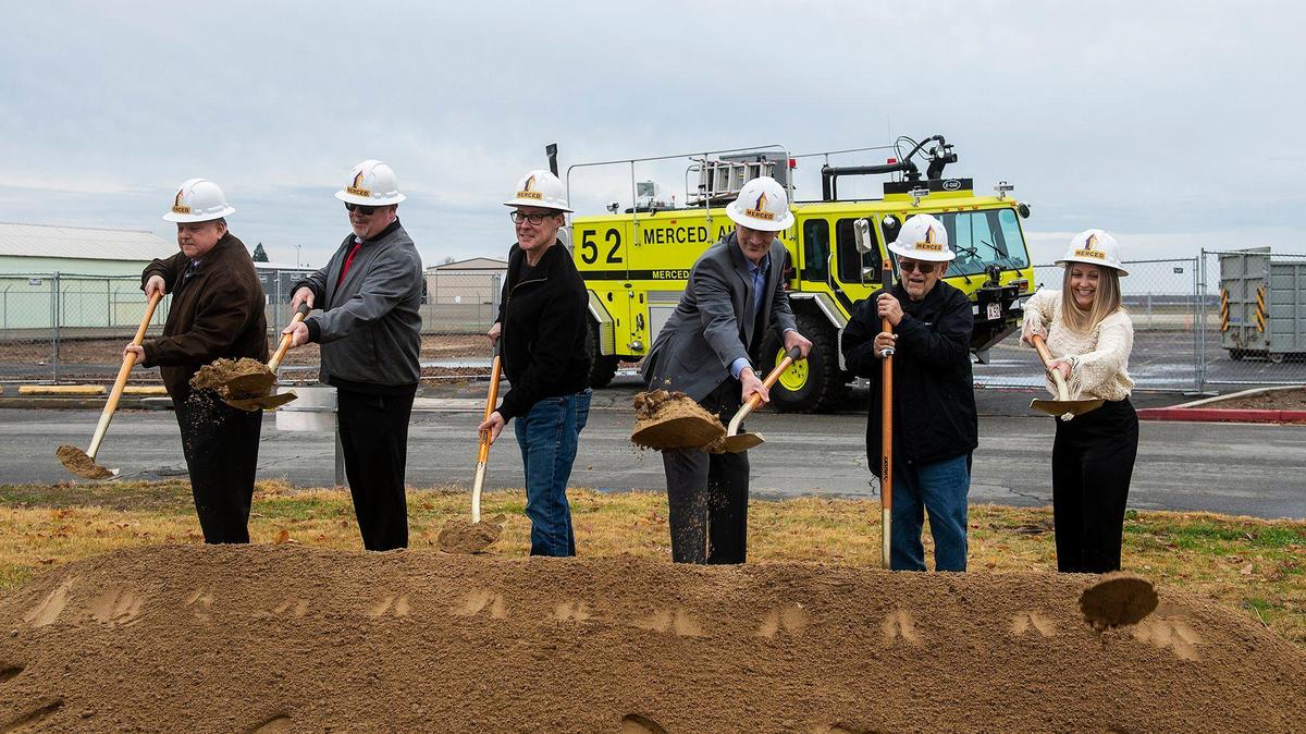 Merced City Council members break ground during a ceremony for a $17 million dollar airport terminal replacement project at the Merced Yosemite Regional Airport in Merced, Calif., on Thursday, Dec. 21, 2023. The project will include updates to the existing 1940s-era terminal as well as the construction of a new energy-efficient and sustainable facility.