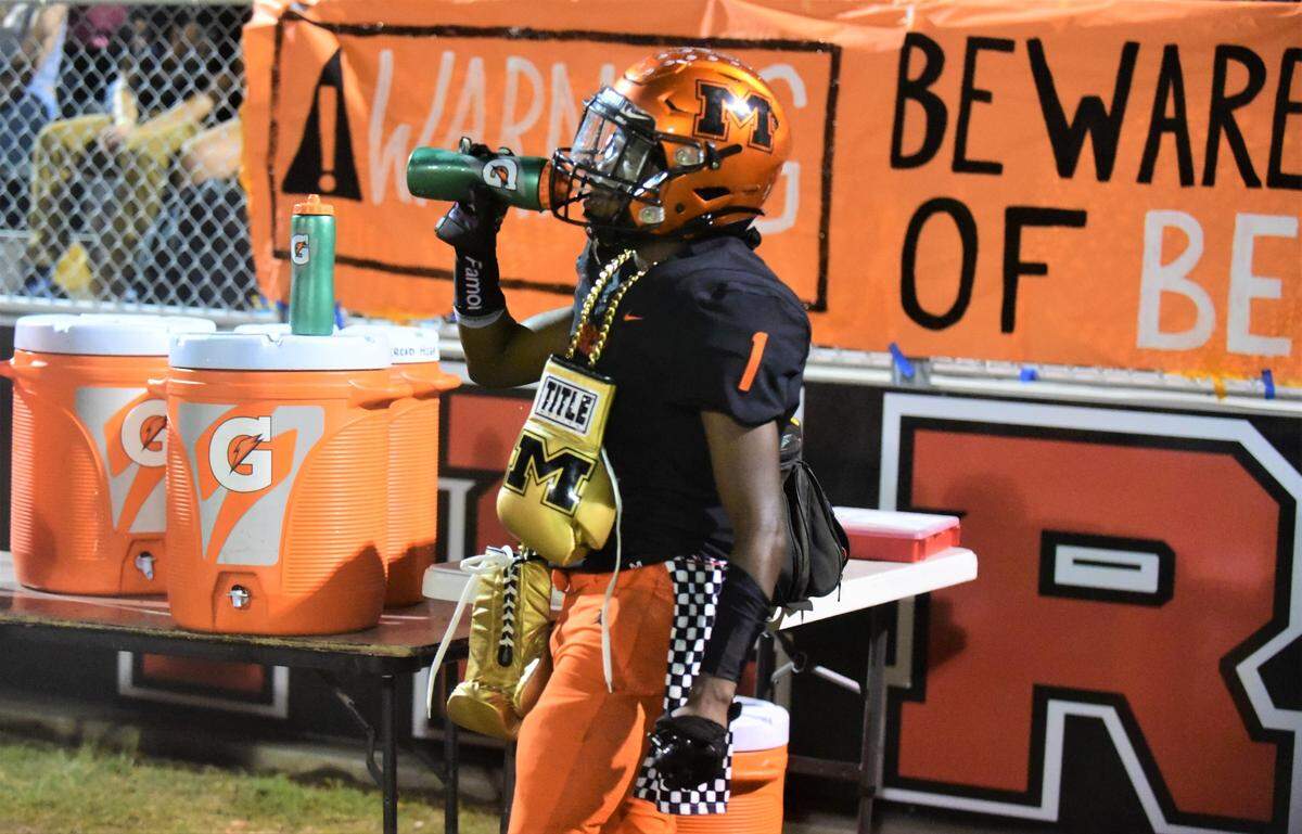 Merced High senior defensive back Dee’arian Barfield grabs a drink on the sideline after making an interception during a game against Patterson on Friday, Sept. 23, 2022.