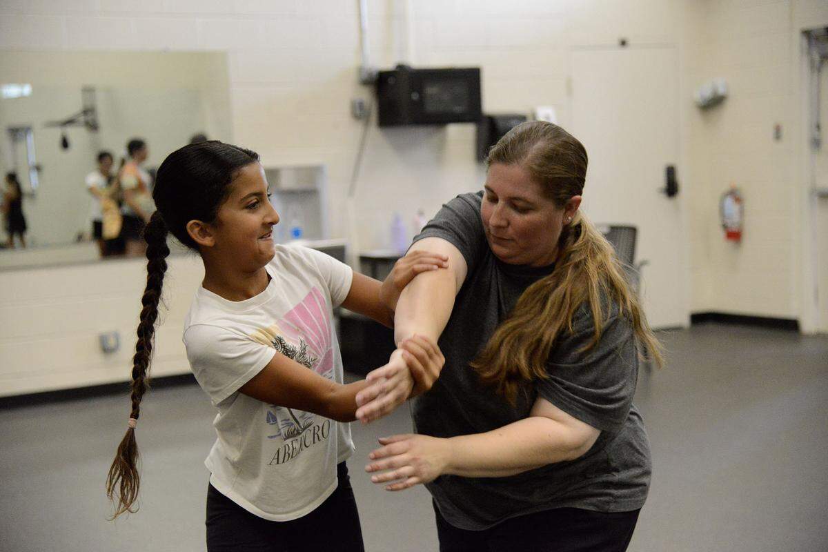 Instructor Amy Rayford practicing self-defense moves with student on Monday June 24, 2024.