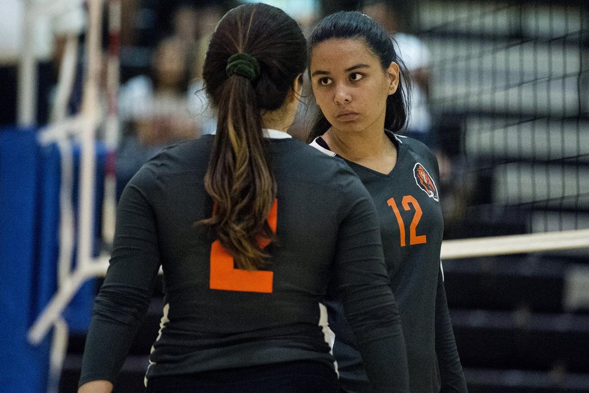 Merced juniors Kayleigh Spencer (12) and Faith Oseguera (2) speak to each other before a Gauchos serve during a match against El Capitan at El Capitan High School in Merced, Calif., on Wednesday, Sept. 12, 2018. The Gauchos beat the Bears 3-0.