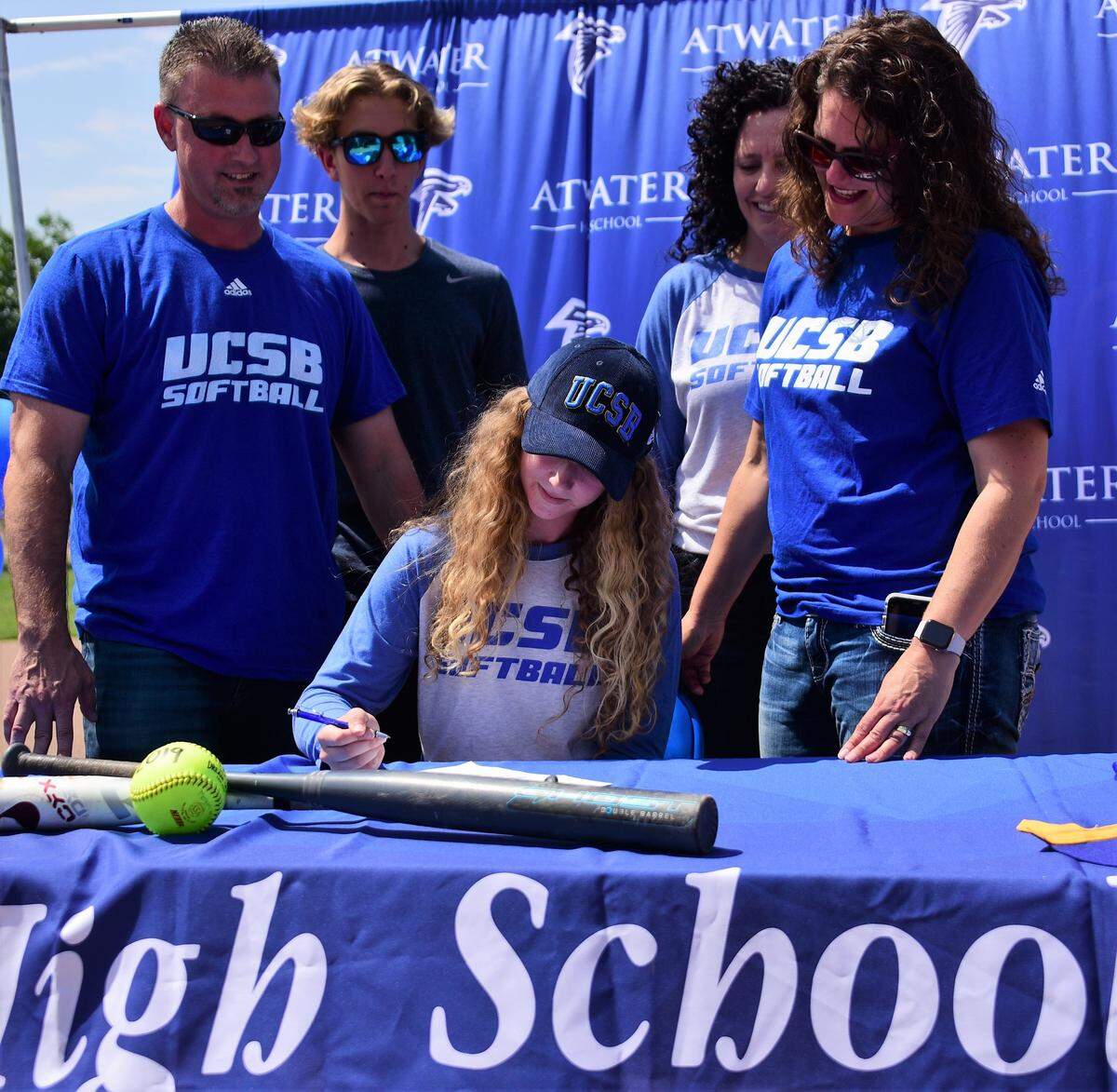 Atwater High senior Megan Escobar signs her national letter of intent to UC Santa Barbara while her family looks on. From left to right: father, Brian, brother, Austin, aunt Dawn Valenta and mother Kori.