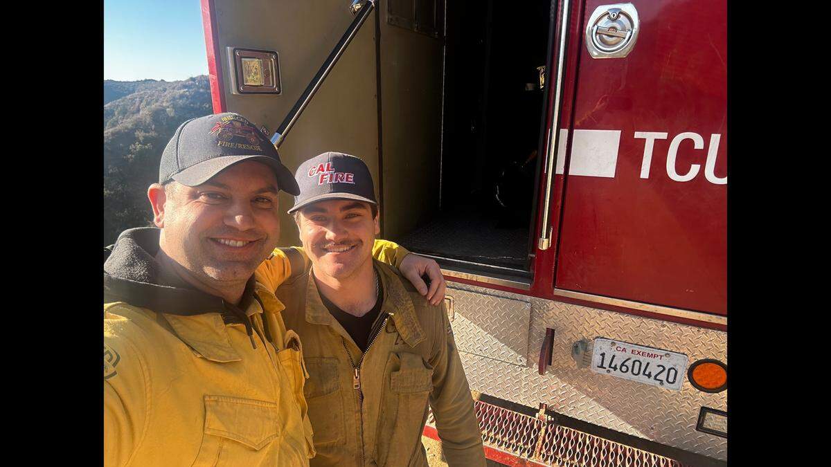 Merced City Fire Captain Bryan Akers, left, with his son Mason, right, while deployed to assist with firefighting efforts on the Palisades Fire in Los Angeles County. Mason works for the Cal Fire Tuolumne-Calaveras Unit. The two ran into each other while deployed to the fire. Image courtesy of Bryan Akers Merced City Fire Department.