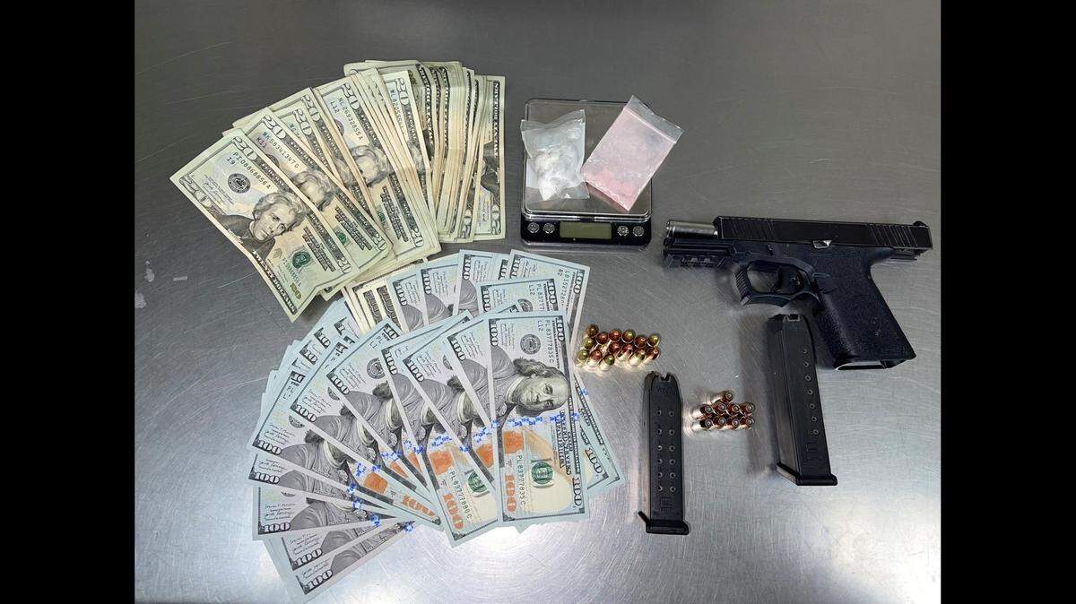 Two suspects were arrested after police found a gun, ammunition, drugs and a large amount of cash in their vehicle after a traffic stop in Merced on Thursday. 